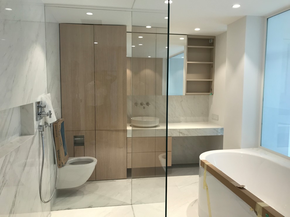 Inspiration for a large contemporary shower room bathroom in Paris with glass-front cabinets, a built-in bath, a built-in shower, a wall mounted toilet, white tiles, ceramic tiles, white walls, ceramic flooring, a built-in sink, tiled worktops, white floors and an open shower.