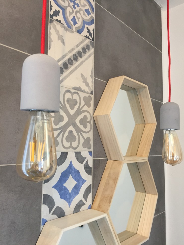 This is an example of a small modern shower room bathroom in Toulouse with grey tiles, cement tiles, grey walls, medium hardwood flooring, a built-in sink and brown floors.