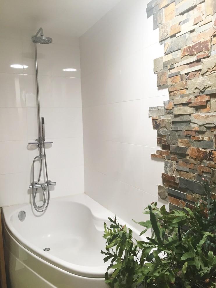 Inspiration for a rural bathroom in Other with white cabinets, a corner bath, a corner shower, a wall mounted toilet, white tiles, ceramic tiles, white walls, dark hardwood flooring, a built-in sink, wooden worktops, brown floors and an open shower.