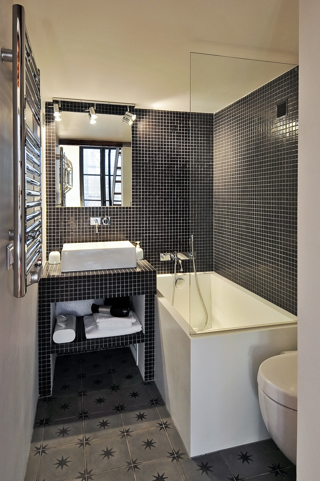 Inspiration for a small contemporary ensuite bathroom in Paris with a vessel sink, tiled worktops, a shower/bath combination, black tiles, mosaic tiles and white walls.