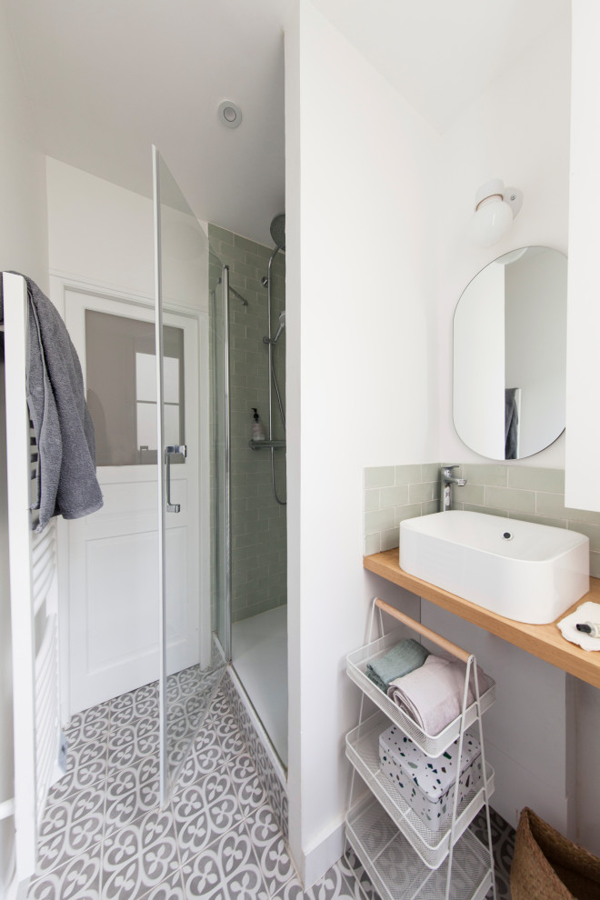 Exemple d'une petite salle d'eau avec WC suspendus, un carrelage vert, un carrelage métro, un mur blanc, un plan vasque, un plan de toilette en bois, une cabine de douche à porte battante et meuble simple vasque.