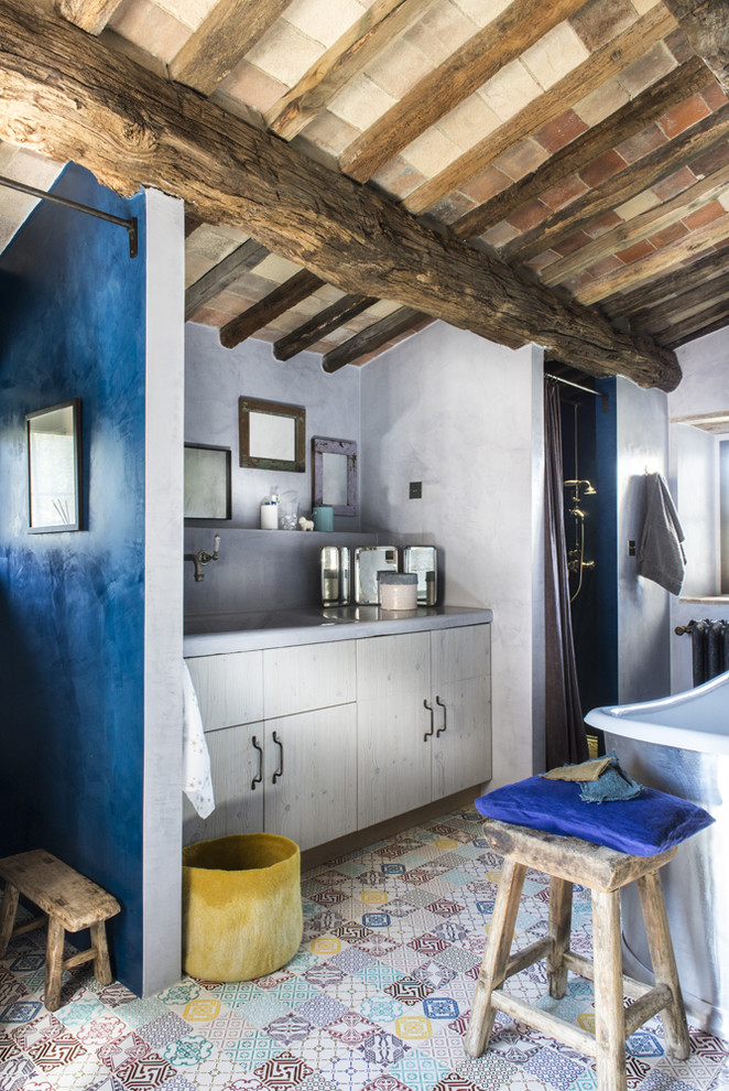 This is an example of a country 3/4 bathroom in Paris with flat-panel cabinets, a freestanding tub, a curbless shower and light wood cabinets.
