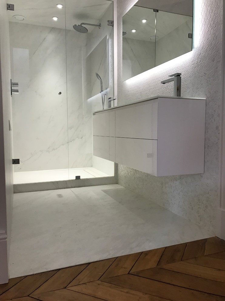 Example of a mid-sized trendy 3/4 white tile and ceramic tile ceramic tile and white floor walk-in shower design in Paris with beaded inset cabinets, white cabinets, white walls, a console sink, tile countertops and a hinged shower door