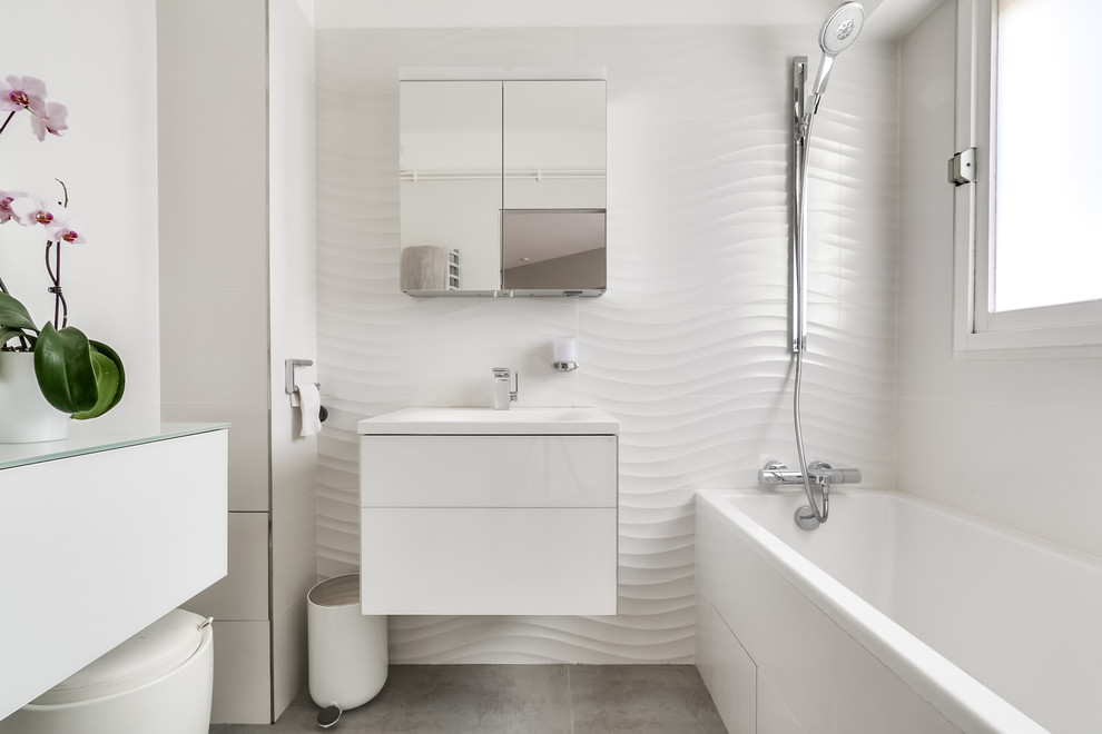 Example of a small trendy master bathroom design in Paris with flat-panel cabinets, white cabinets, white walls and a wall-mount sink