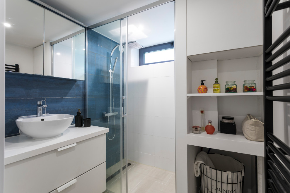 Inspiration for a small contemporary shower room bathroom in Paris with flat-panel cabinets, white cabinets, a built-in shower, blue tiles, ceramic tiles, white walls, ceramic flooring, a built-in sink, laminate worktops, beige floors, a sliding door, white worktops, a single sink and a floating vanity unit.