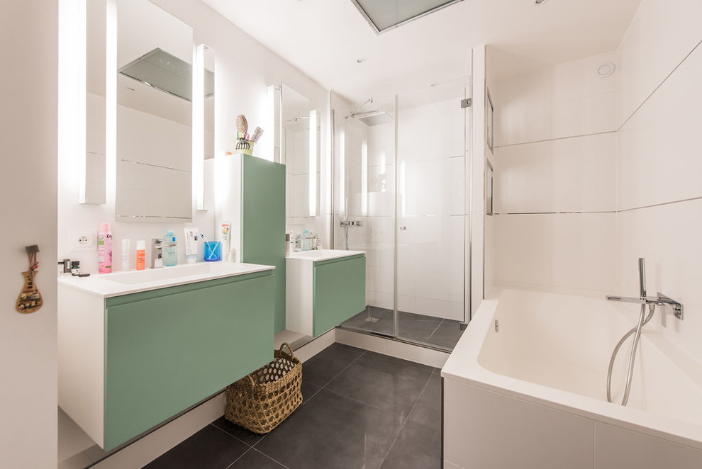 Inspiration for a large contemporary master white tile and ceramic tile ceramic tile, gray floor and double-sink bathroom remodel in Paris with green cabinets, white walls, a console sink, a hinged shower door and a floating vanity