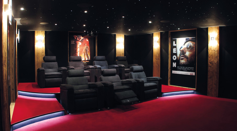 Esempio di un grande home theatre design con pareti nere, moquette e pavimento rosso