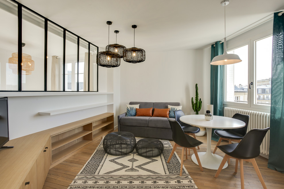 Идея дизайна: открытая гостиная комната среднего размера в скандинавском стиле с белыми стенами, светлым паркетным полом и отдельно стоящим телевизором