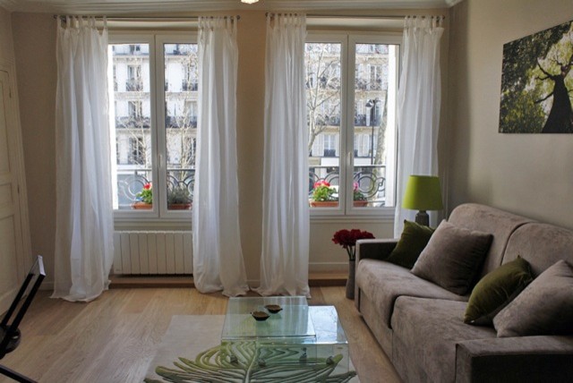 Kleines Modernes Wohnzimmer mit weißer Wandfarbe, hellem Holzboden und beigem Boden in Paris