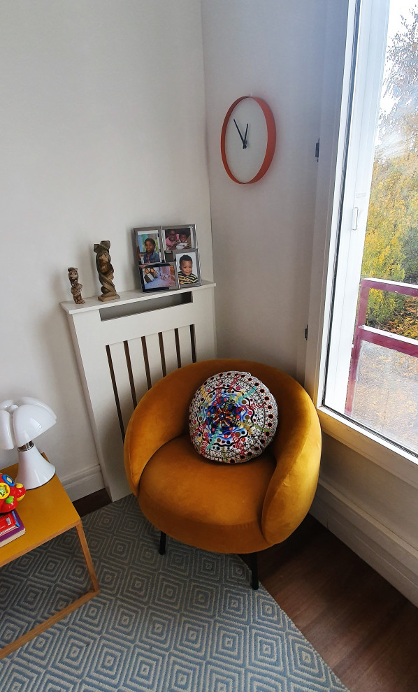 Modelo de sala de estar actual pequeña con paredes blancas, suelo de linóleo, televisor colgado en la pared y suelo marrón