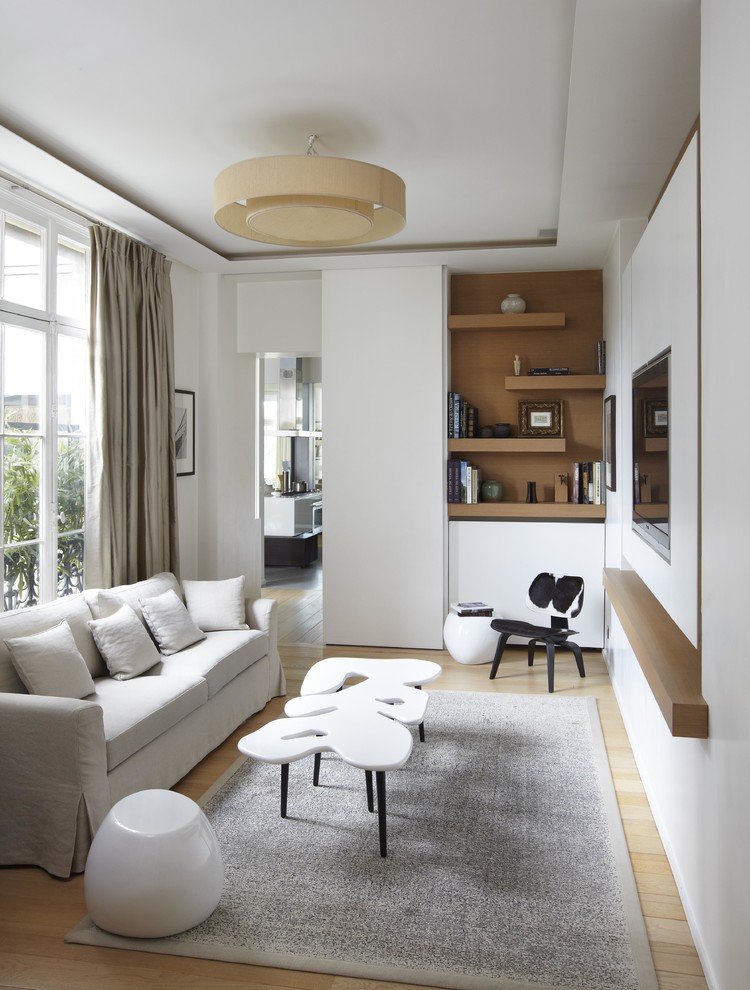 Example of a mid-sized danish open concept light wood floor family room design in Paris with white walls, no fireplace and a wall-mounted tv