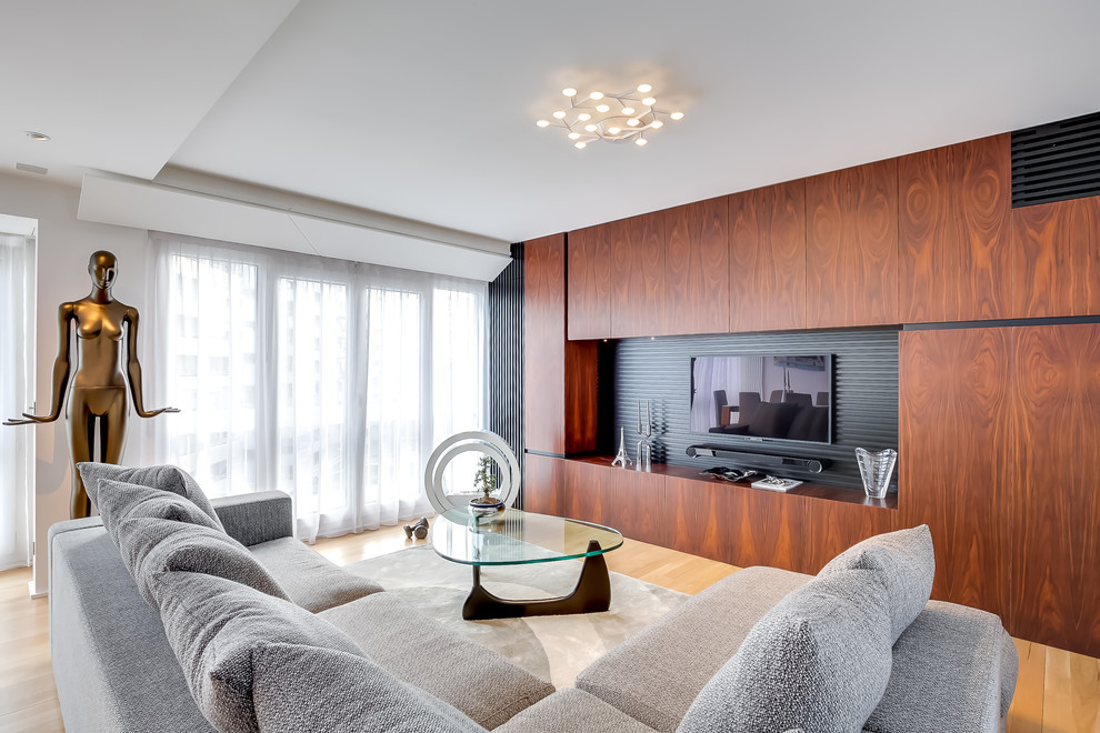 Cette image montre une salle de séjour design de taille moyenne et fermée avec un mur marron, un sol en bois brun et un téléviseur fixé au mur.