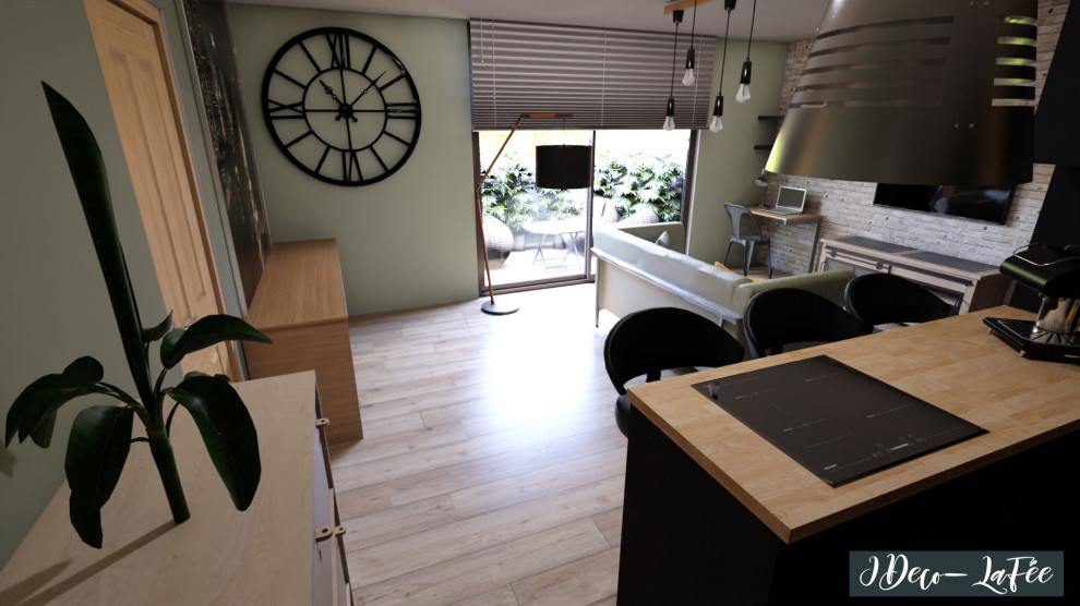 Aménagement d'une petite salle de séjour industrielle ouverte avec un mur vert, sol en stratifié, un téléviseur fixé au mur et un sol marron.