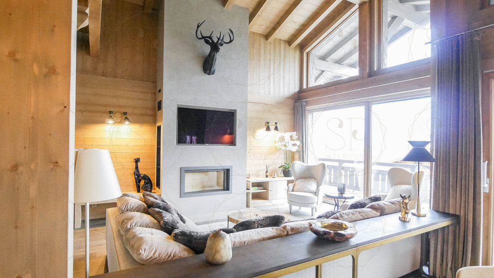 Inspiration for a large rustic open concept light wood floor and beige floor family room remodel in Lyon with beige walls, a ribbon fireplace and a wall-mounted tv