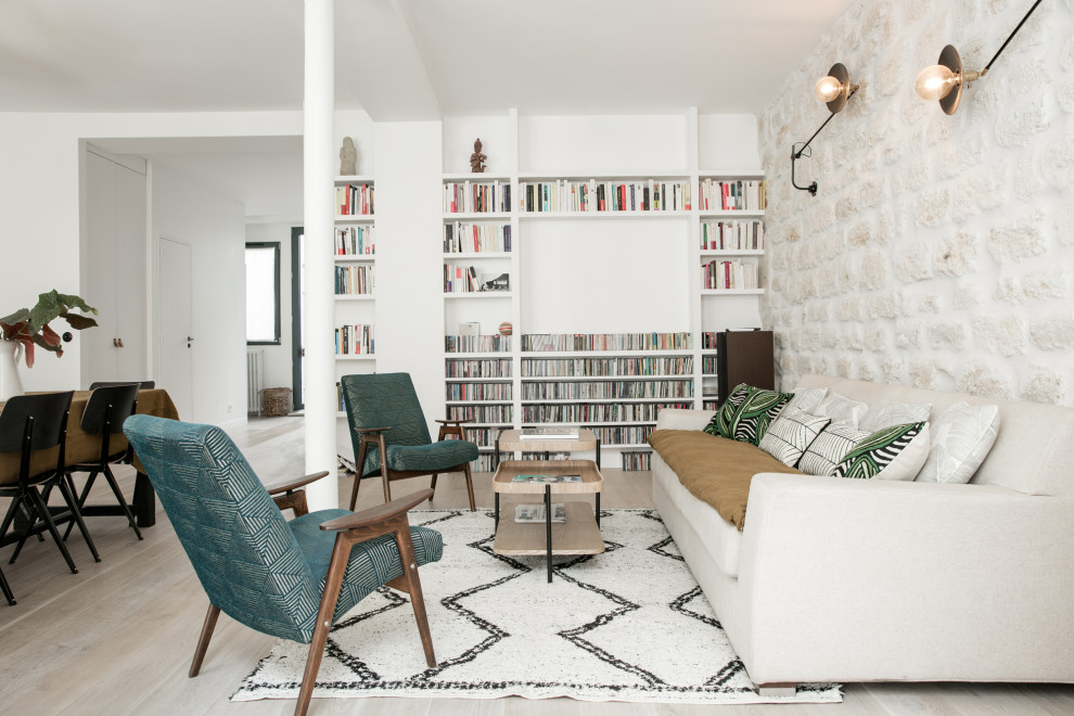 Example of a danish light wood floor family room design in Paris with beige walls