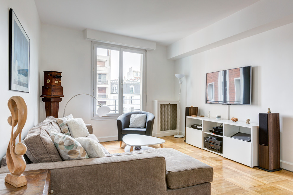 Photo of a medium sized scandi open plan games room in Paris with white walls, medium hardwood flooring, no fireplace, a wall mounted tv and brown floors.