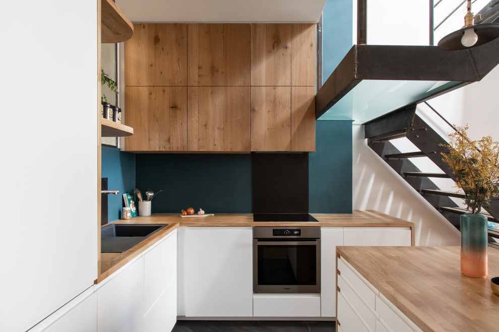 Medium sized industrial kitchen in Paris with ceramic flooring and grey floors.