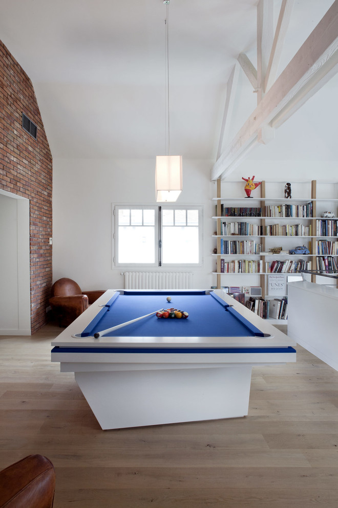 Inspiration for a large eclectic open plan games room in Paris with white walls, medium hardwood flooring, no fireplace, no tv, a game room, brown floors and exposed beams.