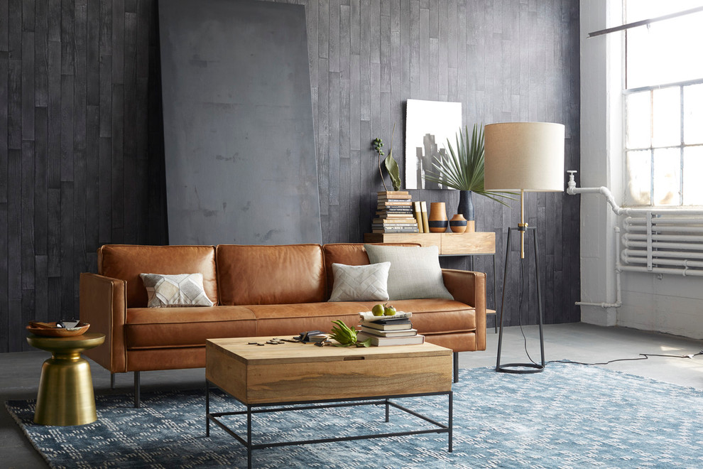 Стильный дизайн: открытая гостиная комната среднего размера в современном стиле с серыми стенами, бетонным полом и коричневым диваном без камина - последний тренд