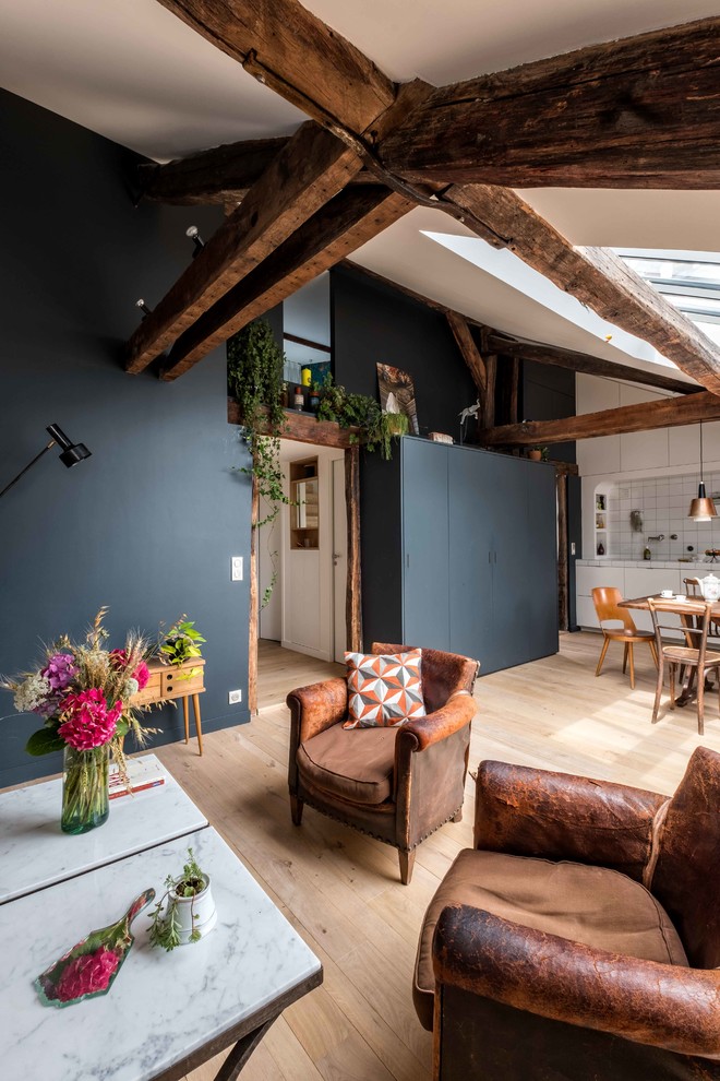 Medium sized contemporary open plan games room in Paris with blue walls, light hardwood flooring, a freestanding tv and beige floors.