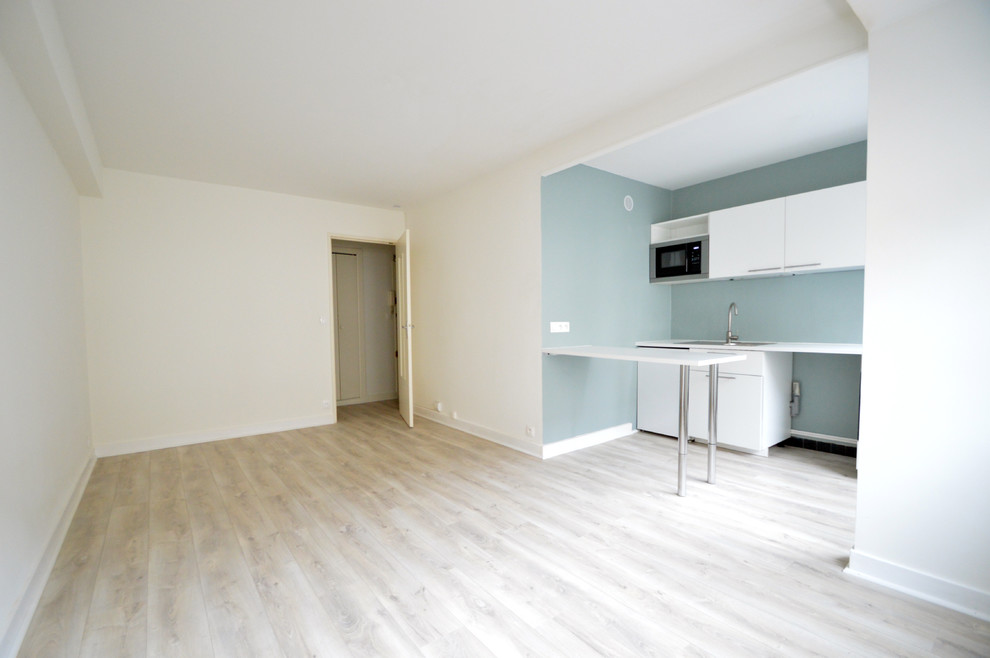 Offenes Modernes Wohnzimmer ohne Kamin mit Hausbar, grüner Wandfarbe und Sperrholzboden in Angers