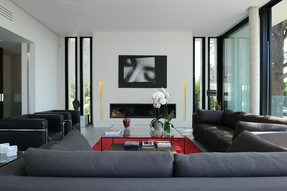 Großes, Offenes Modernes Wohnzimmer mit weißer Wandfarbe, Betonboden und Gaskamin in Lyon