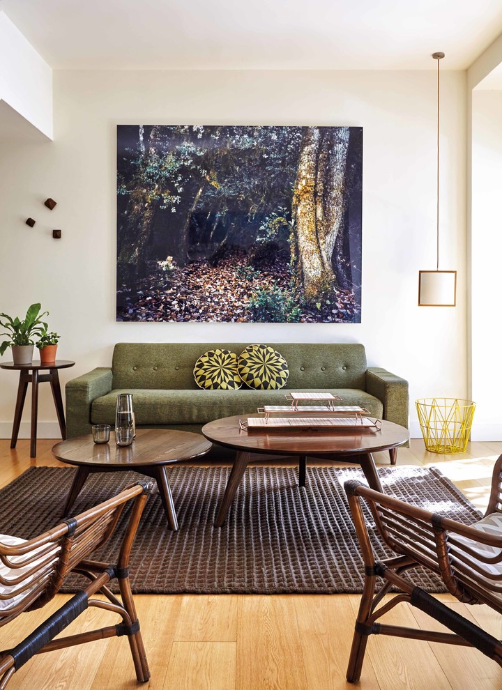 Example of a mid-sized mid-century modern formal and open concept light wood floor living room design in Other with white walls, no fireplace and no tv