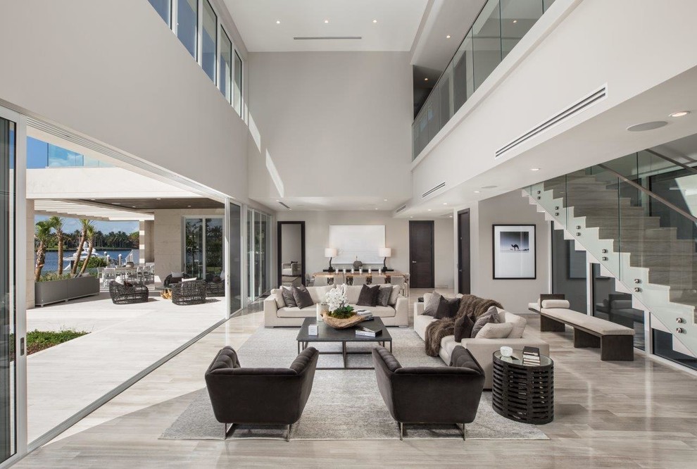 Photo of a contemporary formal open plan living room in Miami with beige floors.