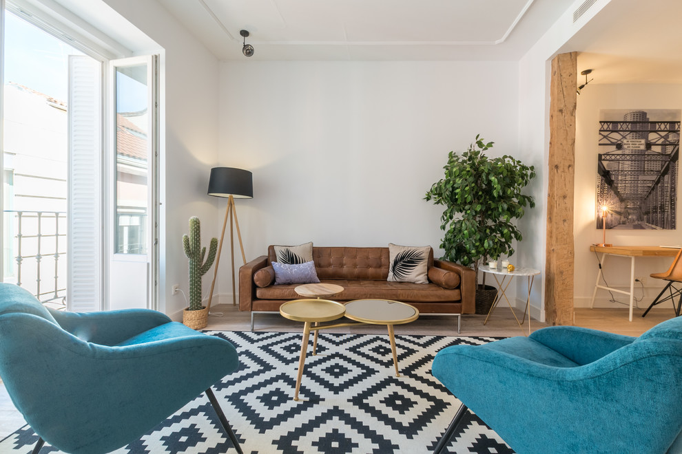 Example of a danish formal and enclosed light wood floor and beige floor living room design in Madrid with white walls