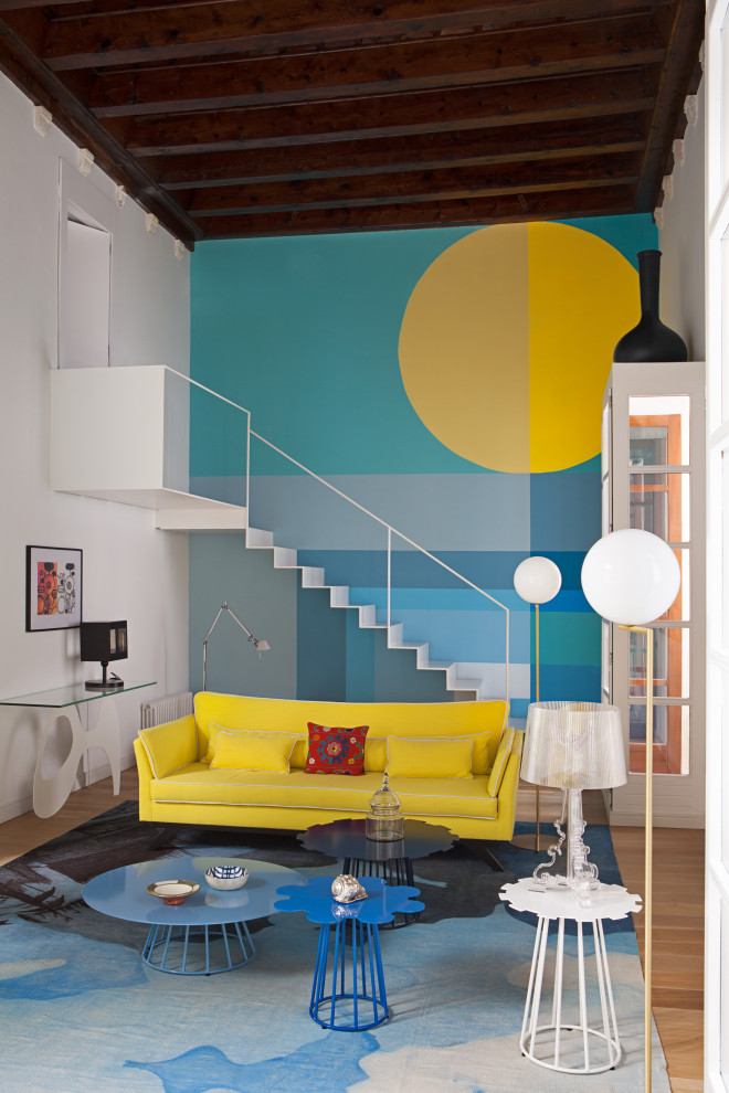 Immagine di un soggiorno boho chic aperto con pareti blu, pavimento in legno massello medio e pavimento marrone