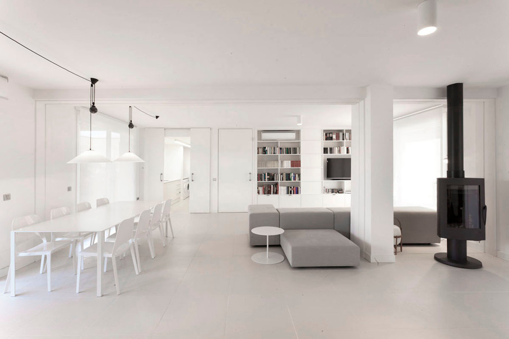 Пример оригинального дизайна: огромная парадная, открытая гостиная комната в стиле модернизм с белыми стенами, полом из керамической плитки и печью-буржуйкой без телевизора