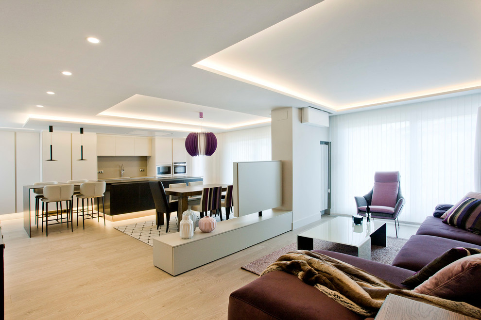 На фото: большая открытая гостиная комната в современном стиле с серыми стенами, полом из керамогранита, отдельно стоящим телевизором и коричневым полом