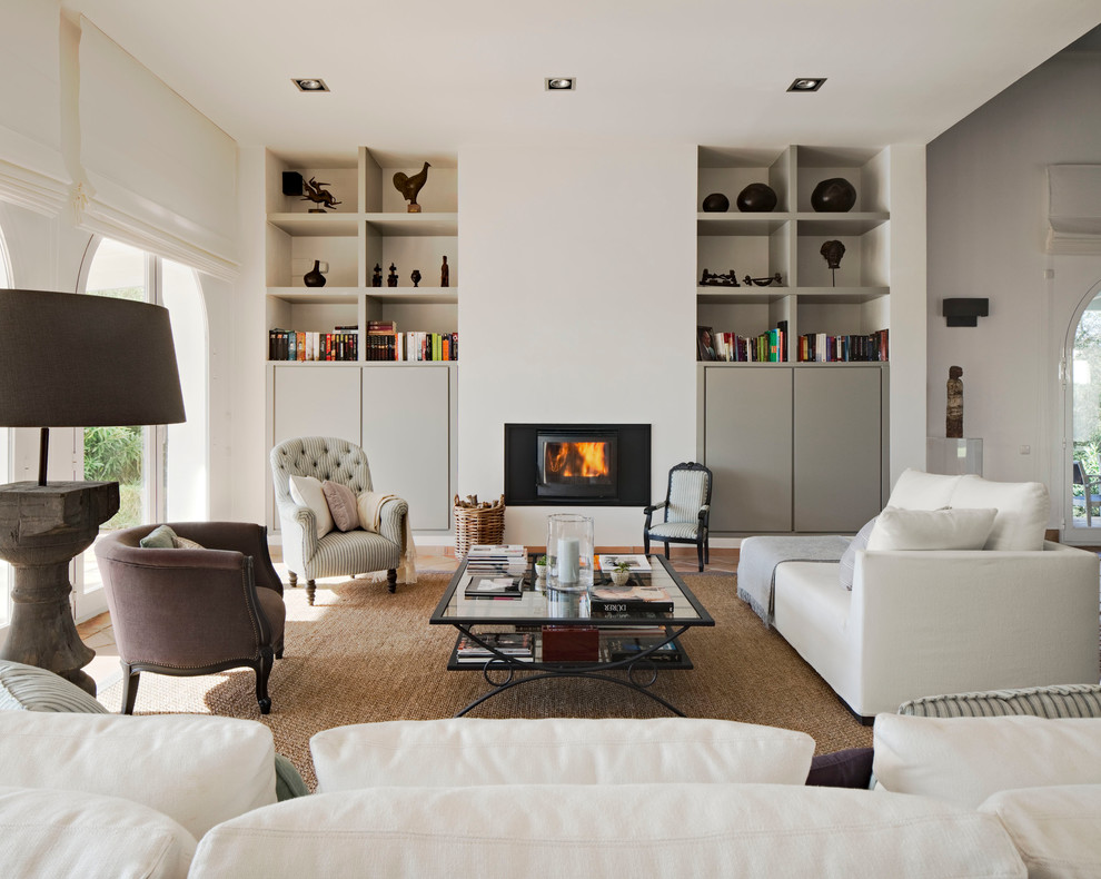 Large classic formal open plan living room in Madrid with white walls, terracotta flooring, a wood burning stove, a metal fireplace surround and no tv.