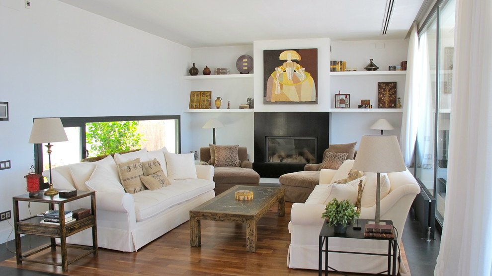 Mid-sized farmhouse formal and open concept medium tone wood floor living room photo in Madrid with white walls, a standard fireplace and no tv