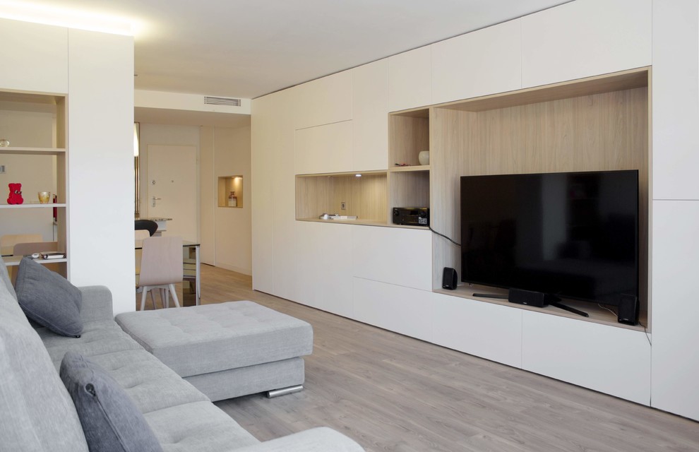 Example of a small minimalist open concept light wood floor living room design in Other with white walls, no fireplace and a tv stand