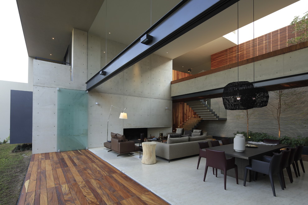 Photo of a contemporary living room in Mexico City with grey walls and grey floors.