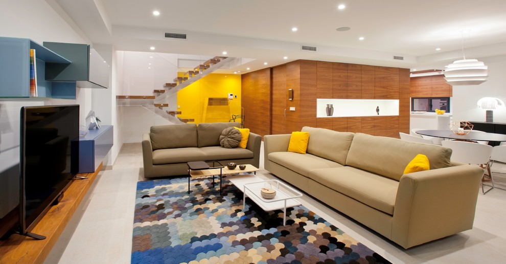 This is an example of a large contemporary open plan living room in Alicante-Costa Blanca with yellow walls, ceramic flooring, a freestanding tv and beige floors.