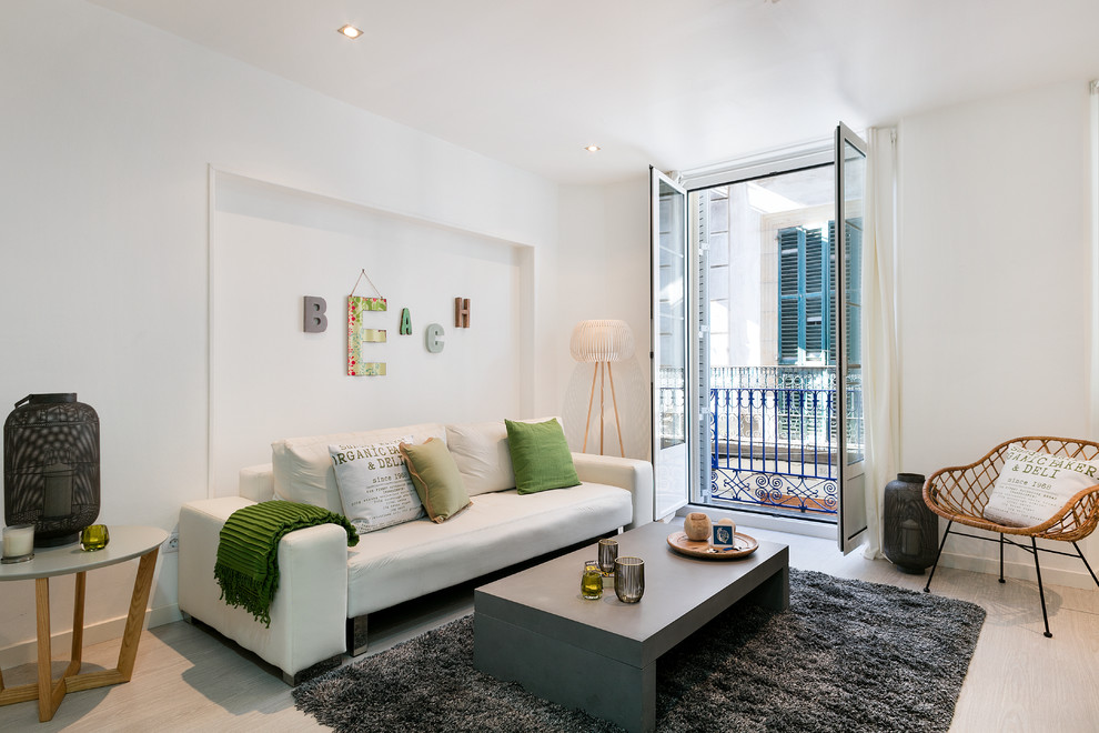 Inspiration for a mid-sized contemporary formal and open concept light wood floor living room remodel in Barcelona with white walls, no fireplace and no tv