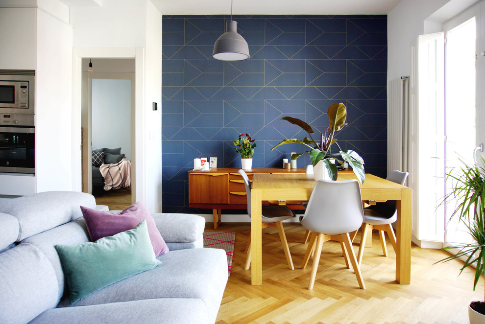 Diseño de salón abierto escandinavo de tamaño medio sin chimenea con paredes azules, suelo de madera en tonos medios y televisor independiente