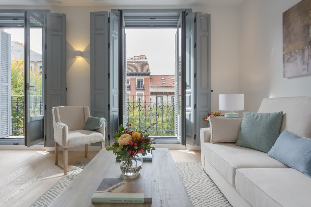 Living room - mediterranean light wood floor and beige floor living room idea in Madrid with white walls