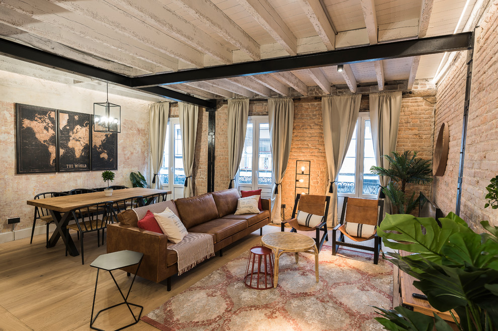 Industrial Wohnzimmer ohne Kamin mit braunem Holzboden und freistehendem TV in Bilbao