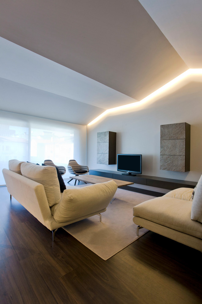 Large modern open plan living room in Other with dark hardwood flooring and a wall mounted tv.