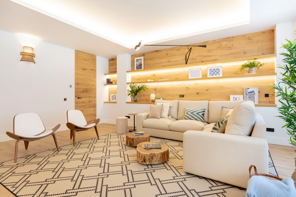 Design ideas for a contemporary formal enclosed living room in Madrid with white walls, light hardwood flooring, no fireplace, no tv and brown floors.