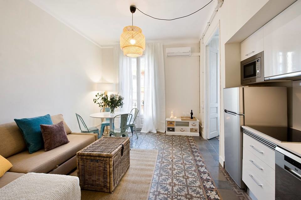 This is an example of a medium sized eclectic formal open plan living room in Barcelona with white walls, ceramic flooring, no fireplace and no tv.