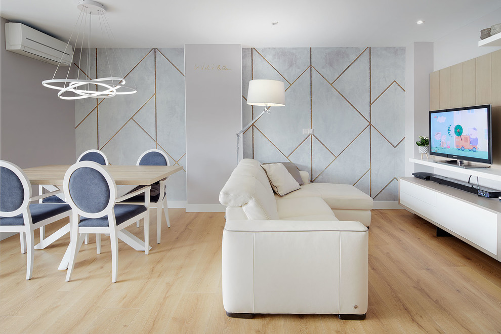 Réalisation d'un salon nordique ouvert avec un mur gris, parquet clair, un téléviseur indépendant et un sol beige.