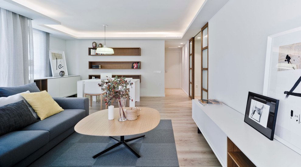 Imagen de salón para visitas abierto moderno de tamaño medio sin chimenea con paredes blancas y suelo de madera clara