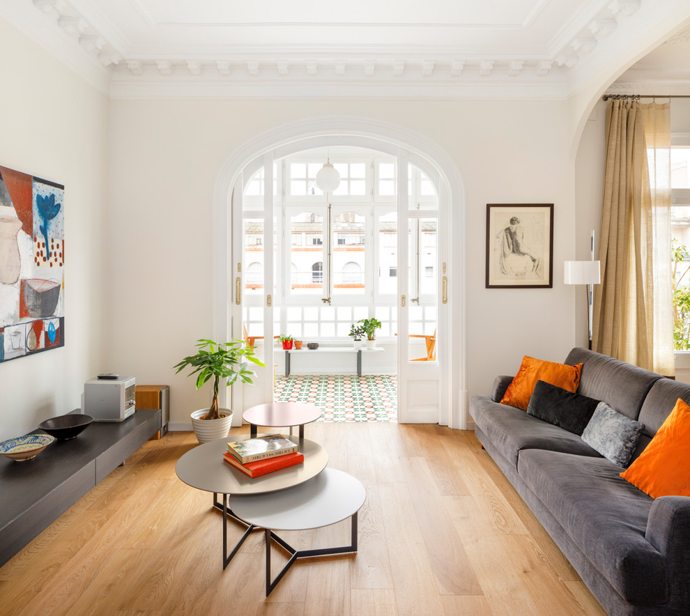 Immagine di un soggiorno minimal aperto con pareti bianche, pavimento in legno massello medio, pavimento marrone e sala formale