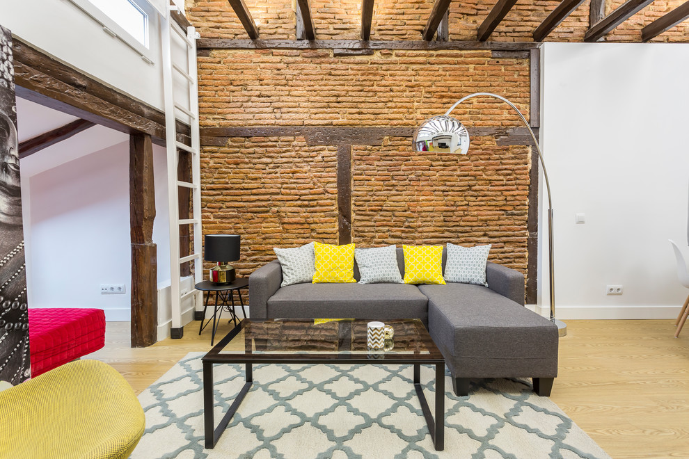 Example of a mid-sized urban open concept light wood floor and beige floor living room design in Madrid with white walls and no fireplace