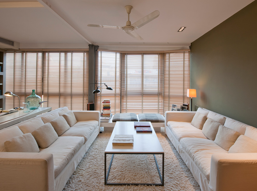 Photo of a medium sized scandi formal enclosed living room in Barcelona with carpet, no fireplace, no tv and green walls.