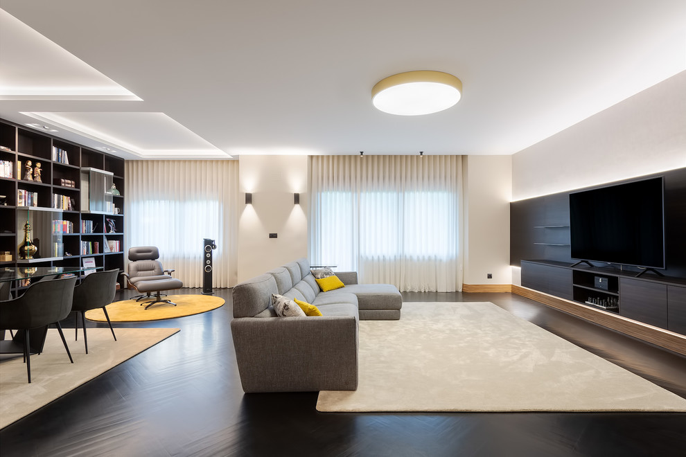 Imagen de salón actual con paredes blancas, suelo de madera pintada, televisor independiente y suelo negro